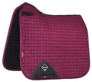 A red and black LeMieux PROSPORT Suede Dressage Square.