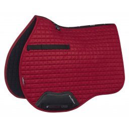 A red and black LeMieux ProSport Suede General Purpose Square saddle pad.