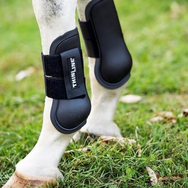ThinLine Schooling Boots - Open Front are shown in a grassy area.