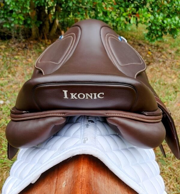 A brown saddle with the word Ikonic Jump "Evolution" - Calf Lined on it.