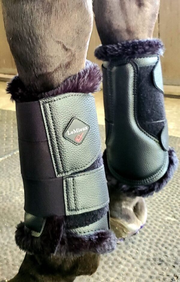 A pair of LeMieux Fleece Lined Brush Boots with fur on them.