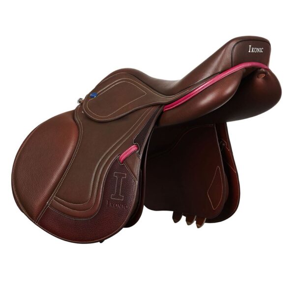 A brown Ikonic Jump "Evolution" - Calf Lined saddle with pink accents.