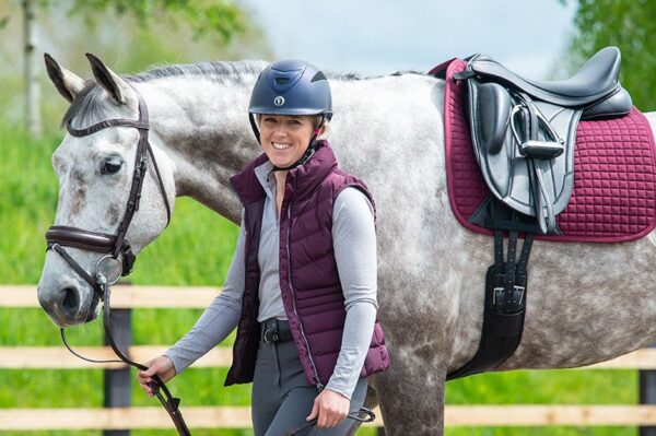 A woman is standing next to a horse wearing a Kent & Masters Competition Series Monoflap Dressage.