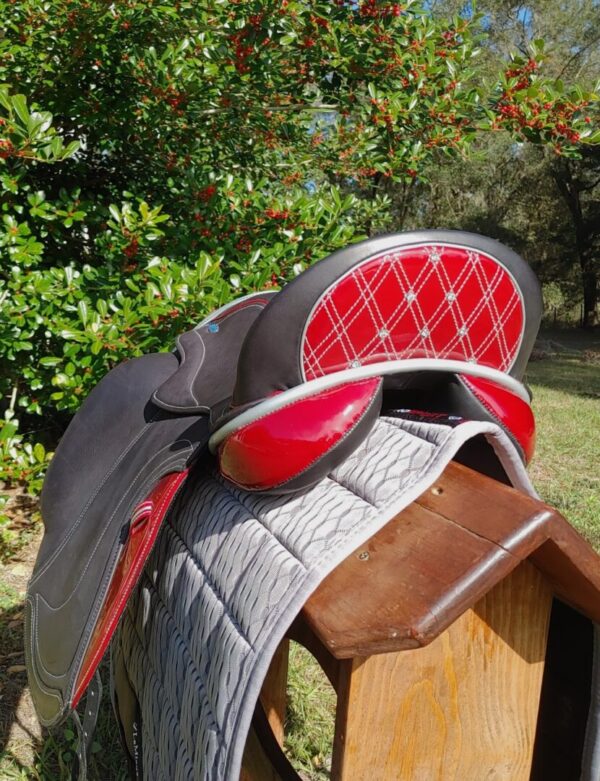 A Ryder Excellence Monoflap Dressage R32 sitting on top of a wooden bench.