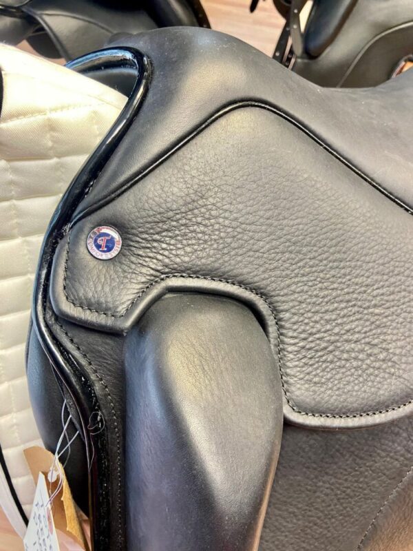A close up of a Tota Freedom PRO 3 Dressage saddle in a store.