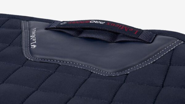 The back of a LeMieux X-Grip Dressage Square with red stitching.