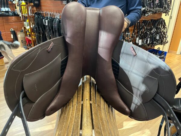 A Tota Freedom JUMP - Event saddle sitting on a table in a shop.