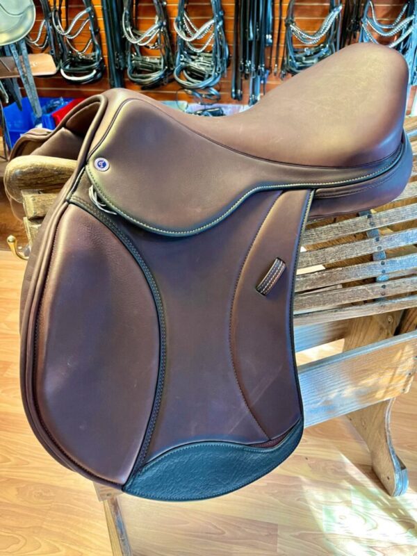A Tota Freedom JUMP - Stadium Saddle sitting on a table in a shop.