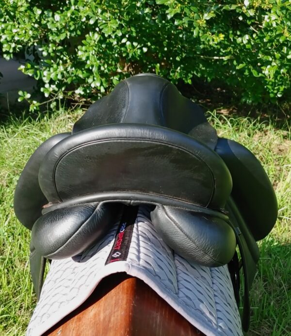 The back of a horse's Custom Wolfgang Solo Dressage UC259 in the grass.