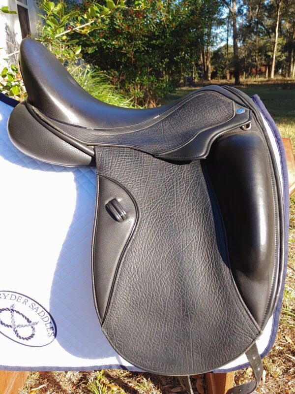 A Ryder Excellence Monoflap Dressage - R11 saddle sitting on top of a white blanket.
