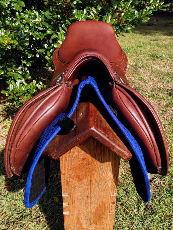 A DEMO - Ryder Riviera Dual Flap Jump saddle with a blue saddle pad on top.