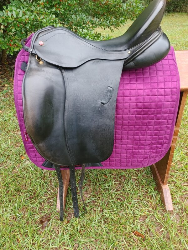 An Albion SLK Ultima Dressage UC265 saddle sitting on a purple blanket.