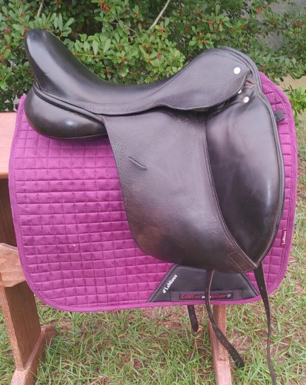 A black Custom Revolution Dressage UC266 sitting on top of a purple blanket.