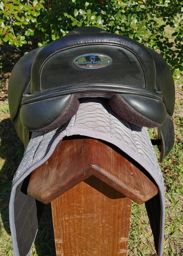 A Frank Baines Pirouette Monoflap Dressage – UC272 sitting on top of a wooden bench.