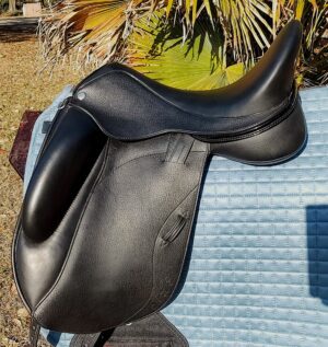 Black leather horse saddle on blue quilted pad