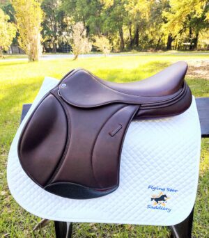 Dark brown jump saddle on quilted pad