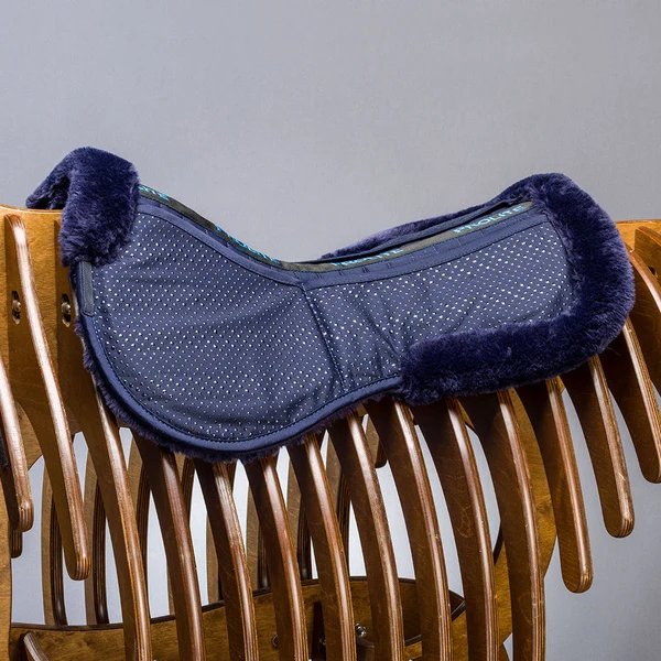 Navy fleece trimmed saddle pad on wooden rack